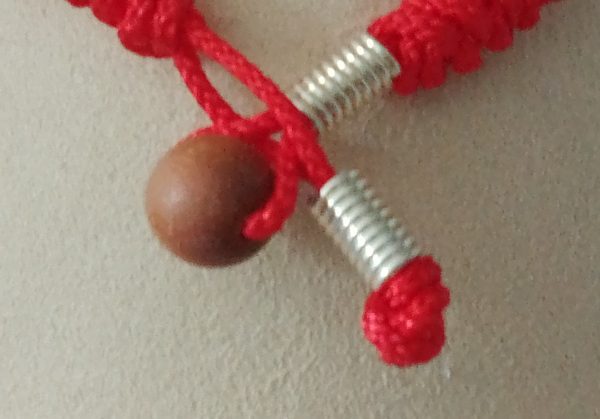 A hand knotted red coloured bracelet with Tiger Charm - Image 2